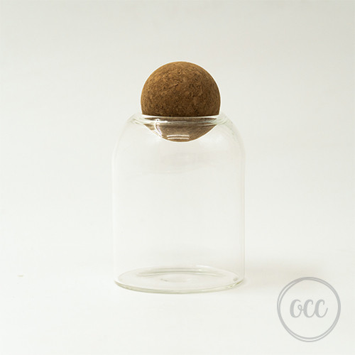 Glass container with round felt lid